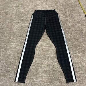 ALO black and gray plaid leggings with reflective stripe-white on side. Size 8.